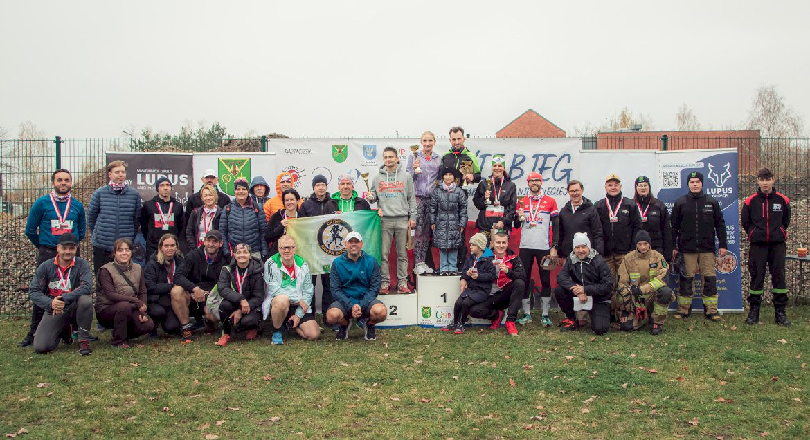 uczestnicy biegu na podium i wokół niego