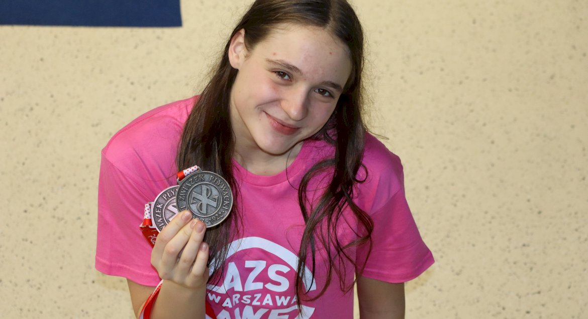 Na zdjęciu zawodniczka Antonina Pietuch w różowej koszulce i medalami w ręku