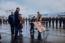 Na zdjęciu starosta przy sztandarze, na placu, w tle żołnierze, flagi polski, fot. DWOT