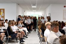 Zdjęcie wykonano podczas rozpoczecia roku w LO im. Stanisława Lema. Na korytarzu młodziez oraz nauczyciele i goście w odświętnych strojach.